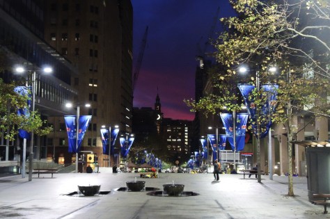 Distant sunset down the Martin Place pedestrian mall frocked with flags from the ANZAC (Veteran's Day) commemoration on this site the prior day. Let's pretend that's the moon in the middle and not a portion of the clock face on the tower.