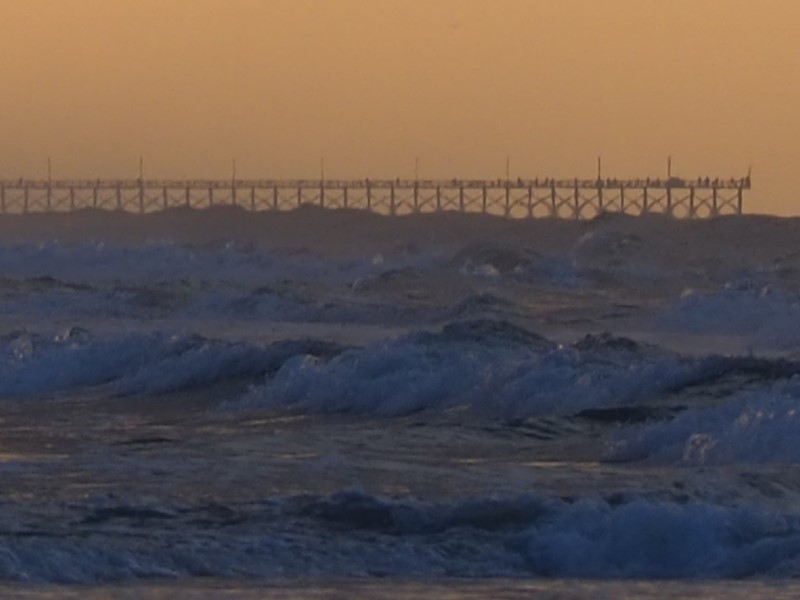 Alt: Distant pier fishermen